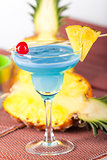 Blue alcohol cocktail with cherry