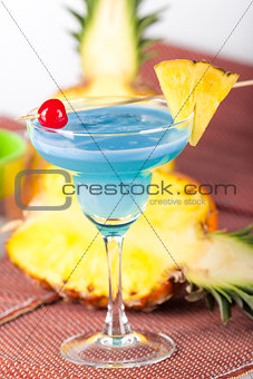 Blue alcohol cocktail with cherry