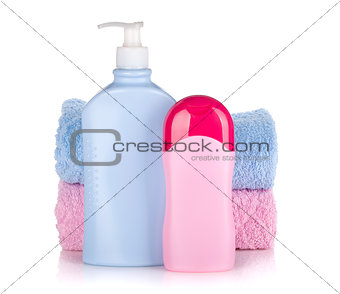 Shampoo and gel bottles with towels