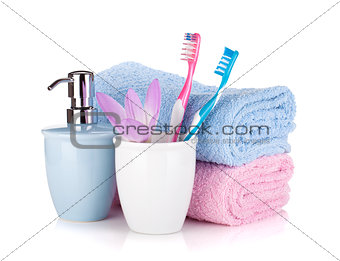 Toothbrush, soap, two towels and flower