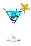 Blue cocktail with carambola in martini glass