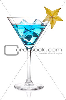 Blue cocktail with carambola in martini glass