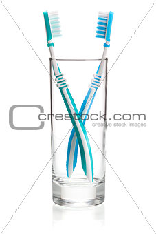 Two tooth brushes in glass