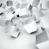 Falling and hitting gray metallic cubes on a white background