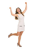 Full length portrait of happy young woman rejoicing success