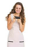 Smiling young woman writing sms