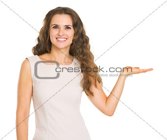 Smiling young woman presenting something on empty palm