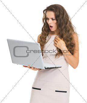 Surprised young woman with laptop