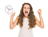 Stressed young woman with clock