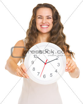 Closeup on clock in hand of smiling young woman
