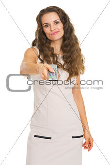 Unhappy young woman switching channels with tv remote control