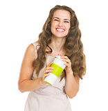 Portrait of smiling young woman with cup of hot beverage