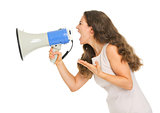 Angry young woman shouting through megaphone