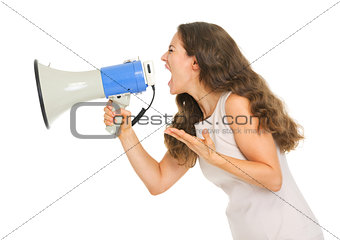 Angry young woman shouting through megaphone