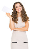 Thoughtful young woman holding letter