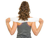 Fitness young woman with towel. rear view