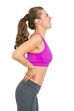 Fitness young woman with back pain