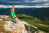 Girl meditation at the mountains