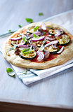 Pizza with grilled zucchini and pine nuts