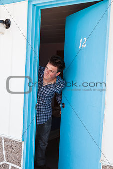 Young man looks out of the motel room