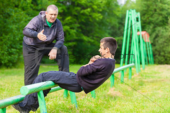 Father and son engaged in athletic exercises