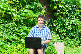 Boy with headphones, Mic and PC at outdoors