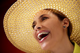 pretty woman with straw hat smiling at camera