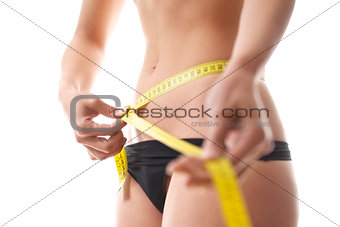 woman measuring waist with tape on white background