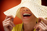 pretty woman with straw hat smiling and having fun