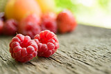 Ripe Sweet Raspberries and Fruits on the Wooden Table