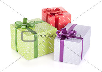 Three colorful gift boxes with ribbon and bow