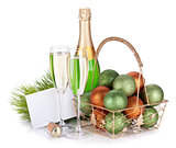 Champagne bottle, glasses, empty gift card and christmas balls