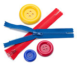 Three colored sewing buttons and two zippers
