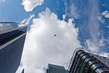 The sky with airplane surrounded by skyscrapers