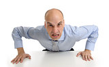 Angry businessman sitting at his desk and screaming