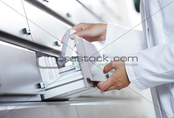 Pharmacist reaching for medicine