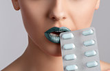 beauty woman mouth with blister of pills