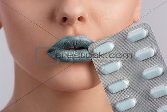 sexy woman mouth with blister of pills 