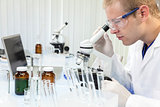 Male Scientist or Doctor Using Laboratory Microscope