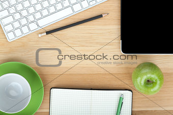 Office supplies, devices, coffee cup and apple