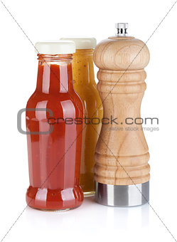 Mustard and ketchup glass bottles with pepper shaker