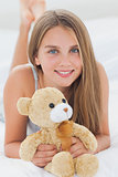 Young girl holding a teddy bear