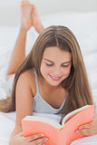 Smiling girl reading a book