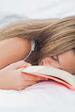 Girl sleeping while holding a book