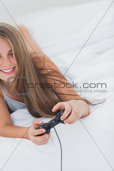 Cheerful young girl playing video games