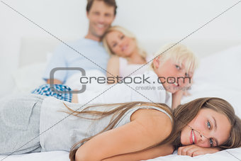 Siblings lying on the bed