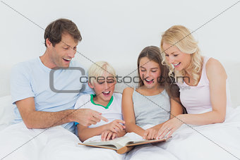Family reading a book together