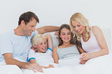 Cheerful family using digital tablet