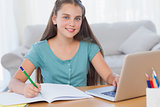 Smiling girl doing her homework