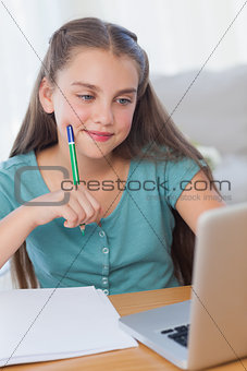 Smiling little girl doing her homework